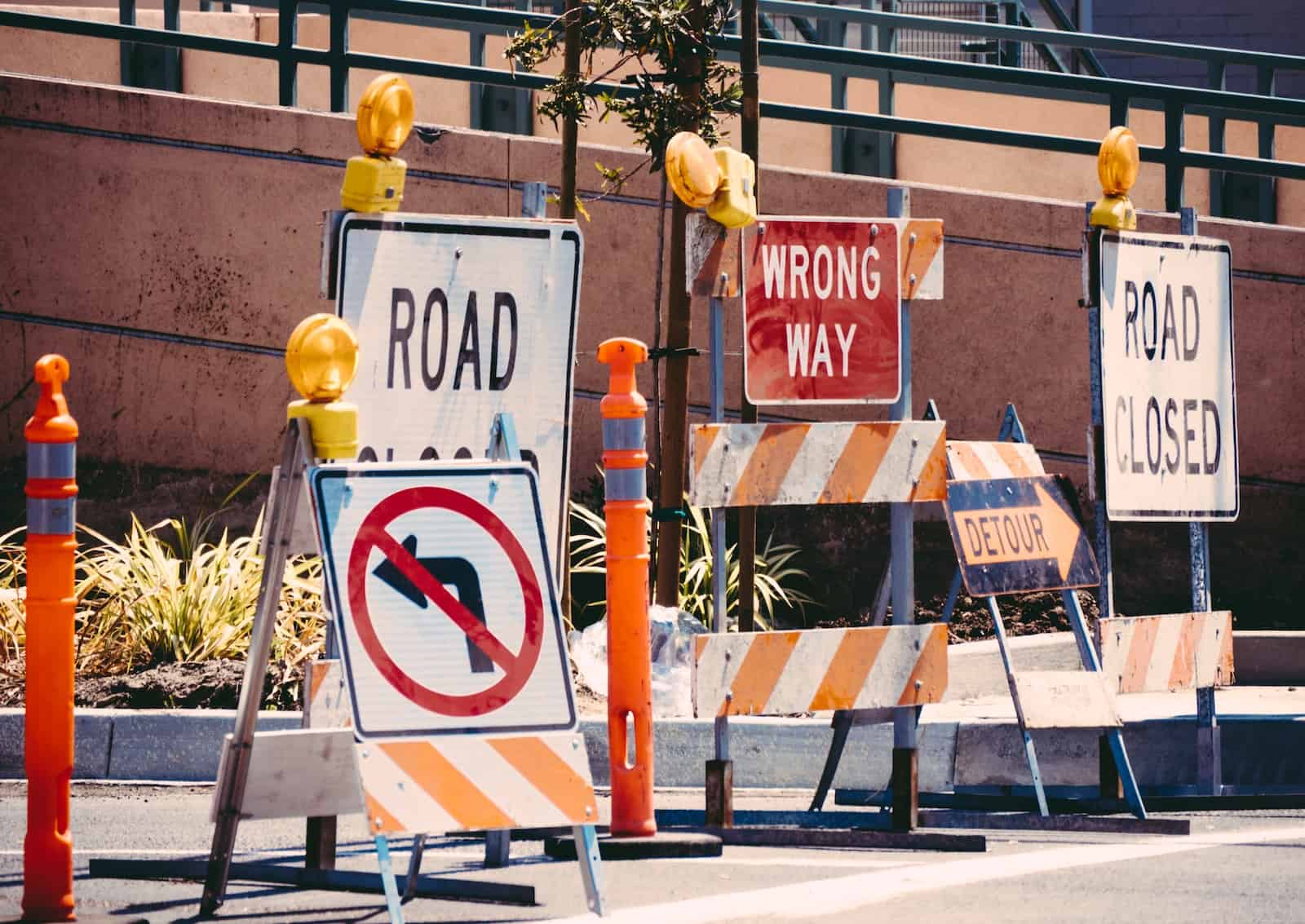 assorted-color signage lot on road during daytime